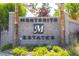 Elegant stone entrance sign for Montecito Estates, surrounded by lush greenery at 179 Adomeit Dr, Henderson, NV 89074