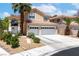 Charming two-story home featuring a well-manicured front yard, three-car garage, and inviting entrance at 179 Adomeit Dr, Henderson, NV 89074