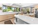 Bright kitchen boasts quartz counters, modern appliances, and large windows with views of the outdoor living space at 179 Adomeit Dr, Henderson, NV 89074