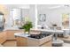 Modern kitchen with a center island cooktop, light wood cabinets, and an open layout to the dining area at 179 Adomeit Dr, Henderson, NV 89074