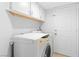 Well-lit laundry room with a washer, dryer, and ample storage space at 179 Adomeit Dr, Henderson, NV 89074