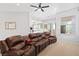 Comfortable living room features a large brown leather sofa and bright, natural light at 179 Adomeit Dr, Henderson, NV 89074