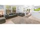 Comfortable living room with neutral tile flooring, two sofas, and large windows for natural light at 179 Adomeit Dr, Henderson, NV 89074