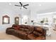 Spacious living room features a leather sofa and open floor plan at 179 Adomeit Dr, Henderson, NV 89074