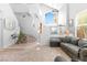 Spacious living room with high ceilings, a staircase, and natural light from large windows at 179 Adomeit Dr, Henderson, NV 89074