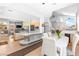 Spacious living area featuring an open-concept kitchen, dining area, and stairs leading to an upper floor at 179 Adomeit Dr, Henderson, NV 89074
