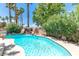 Beautiful pool area with a rock waterfall feature and lush landscaping offering a relaxing outdoor space at 179 Adomeit Dr, Henderson, NV 89074