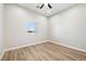 Clean and bright bedroom with a window providing natural light and wood-look floors at 1800 Huckleberry St, Pahrump, NV 89048