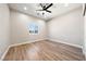 Bedroom featuring wood-look floors, a window with mountain views, and a ceiling fan at 1800 Huckleberry St, Pahrump, NV 89048