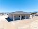Rear exterior of a single story home featuring a spacious patio and neutral color palette at 1800 Huckleberry St, Pahrump, NV 89048