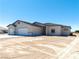 A bright single-story home with a three-car garage and desert landscaping at 1800 Huckleberry St, Pahrump, NV 89048
