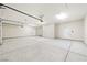 Large three car garage with concrete floors and ample lighting at 1800 Huckleberry St, Pahrump, NV 89048