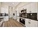 Kitchen showcases stainless steel appliances, dark backsplash, and white cabinets for a modern aesthetic at 1800 Huckleberry St, Pahrump, NV 89048