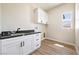 Functional laundry area with granite countertops, white cabinets and natural lighting at 1800 Huckleberry St, Pahrump, NV 89048