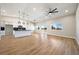 Bright living room with hardwood floors and modern lighting fixtures in neutral color palette at 1800 Huckleberry St, Pahrump, NV 89048