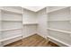 A walk in closet is furnished with shelves and wooden rods at 1800 Huckleberry St, Pahrump, NV 89048
