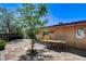 Desert landscaped backyard featuring brick pavers and mature trees at 2402 Saguaro Point St, Las Vegas, NV 89115