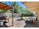 Backyard patio with brick pavers and mature landscaping and block fence at 2402 Saguaro Point St, Las Vegas, NV 89115