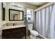 Well-lit bathroom featuring a modern vanity, toilet, and shower with stylish fixtures at 2402 Saguaro Point St, Las Vegas, NV 89115
