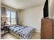 Comfortable bedroom with a large window, TV, and dresser for ample storage at 2402 Saguaro Point St, Las Vegas, NV 89115