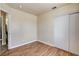 Another bedroom with wood-look floors, neutral paint, closet, and a window for natural light at 2402 Saguaro Point St, Las Vegas, NV 89115
