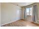 Bedroom with wood-look floors, neutral paint, closet, and a window for natural light at 2402 Saguaro Point St, Las Vegas, NV 89115