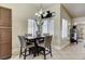Bright breakfast nook features modern chandelier, neutral walls and square dark wood table for four at 2402 Saguaro Point St, Las Vegas, NV 89115