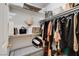 Walk-in closet with ample shelving, hanging space, and a comfortable seating area at 2402 Saguaro Point St, Las Vegas, NV 89115
