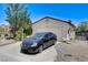 Exterior of the house featuring a two-car garage with a private driveway and manicured landscaping at 2402 Saguaro Point St, Las Vegas, NV 89115