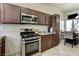 Galley kitchen features stainless steel appliances, tile flooring, and plenty of counter space at 2402 Saguaro Point St, Las Vegas, NV 89115