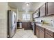 The kitchen features stainless steel appliances, tile flooring, and granite countertops at 2402 Saguaro Point St, Las Vegas, NV 89115