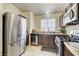 Modern kitchen features stainless steel appliances, tile flooring, and functional layout at 2402 Saguaro Point St, Las Vegas, NV 89115