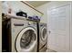 Well-equipped laundry area with modern washer and dryer units for efficient cleaning at 2402 Saguaro Point St, Las Vegas, NV 89115