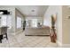 Open-concept living room features neutral tones and tile flooring and leads to the sliding doors at 2402 Saguaro Point St, Las Vegas, NV 89115