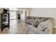 Inviting living room featuring tile flooring, comfortable seating and sliding door access to backyard at 2402 Saguaro Point St, Las Vegas, NV 89115
