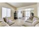 Inviting living room with tiled floors, comfortable seating, and sliding door access at 2402 Saguaro Point St, Las Vegas, NV 89115