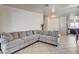 Spacious living room with tile flooring, and an oversized couch, perfect for Gathering gatherings at 2402 Saguaro Point St, Las Vegas, NV 89115
