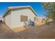 Home's backyard showing the patio, AC unit, and minimal landscaping at 2421 Sunrise Springs Ct, North Las Vegas, NV 89031