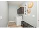 Functional laundry room with washer, dryer, cabinets, and artistic decorations at 2421 Sunrise Springs Ct, North Las Vegas, NV 89031