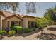 Backyard exterior elevation featuring a covered patio, desert landscaping, and mature trees at 2541 Desert Glen Dr, Las Vegas, NV 89134