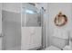 Bathroom shower with glass door, toilet with stacked toilet paper, and decorative wreath at 2541 Desert Glen Dr, Las Vegas, NV 89134
