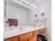 Bathroom featuring wood cabinets, a large mirror, and brushed nickel fixtures at 2541 Desert Glen Dr, Las Vegas, NV 89134