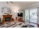An open living room features a fireplace and large sliding door for natural light at 2541 Desert Glen Dr, Las Vegas, NV 89134
