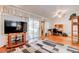 Bright living room featuring laminate flooring, a ceiling fan, and access to office at 2541 Desert Glen Dr, Las Vegas, NV 89134