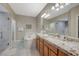 Bathroom featuring a dual sink vanity, soaker tub, walk-in shower, and tile flooring at 2555 Hampton Rd # 5104, Henderson, NV 89052