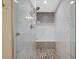 Stylish glass-enclosed shower boasts designer tile and a convenient built-in bench at 2555 Hampton Rd # 5104, Henderson, NV 89052