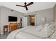 Bedroom with a ceiling fan, a chest of drawers, a television and a view into the bathroom at 2555 Hampton Rd # 5104, Henderson, NV 89052