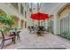 Scenic courtyard with bistro seating, red umbrella, and ambient string lights at 2555 Hampton Rd # 5104, Henderson, NV 89052