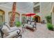 Beautiful courtyard with comfortable seating, red umbrella, and lush landscaping at 2555 Hampton Rd # 5104, Henderson, NV 89052