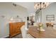 Bright dining room with a chandelier, wooden furniture, and a view into the living area at 2555 Hampton Rd # 5104, Henderson, NV 89052